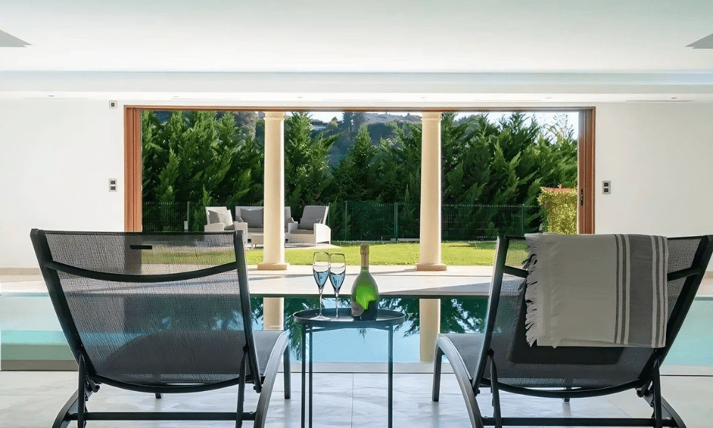Villa Hotel Galets in Cagnes-sur-Mer, French Riviera, France – stylish bar lounge with backlit spirits display and leather stools