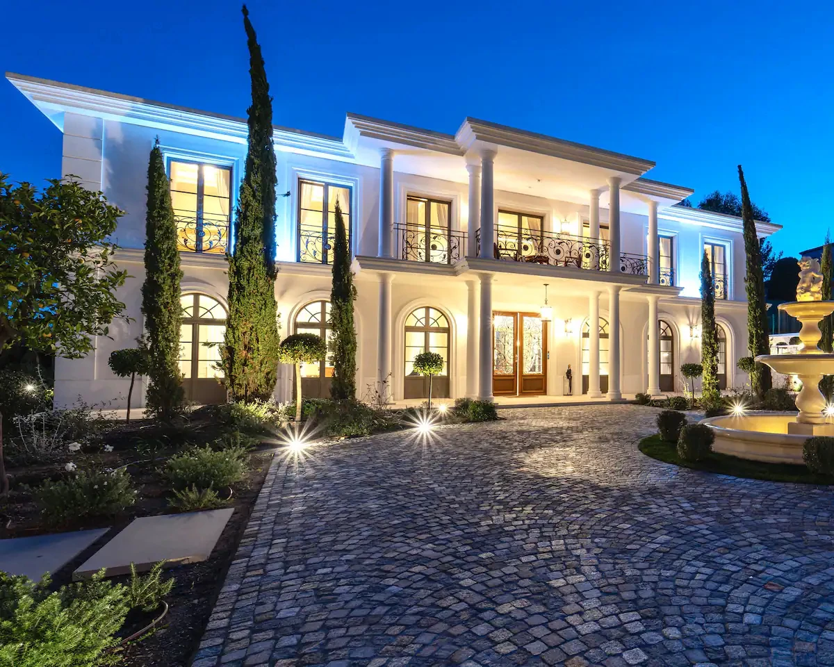 Front façade of Villa Hotel Brougham in Cannes, French Riviera, France – grand entrance with ornate columns and manicured grounds