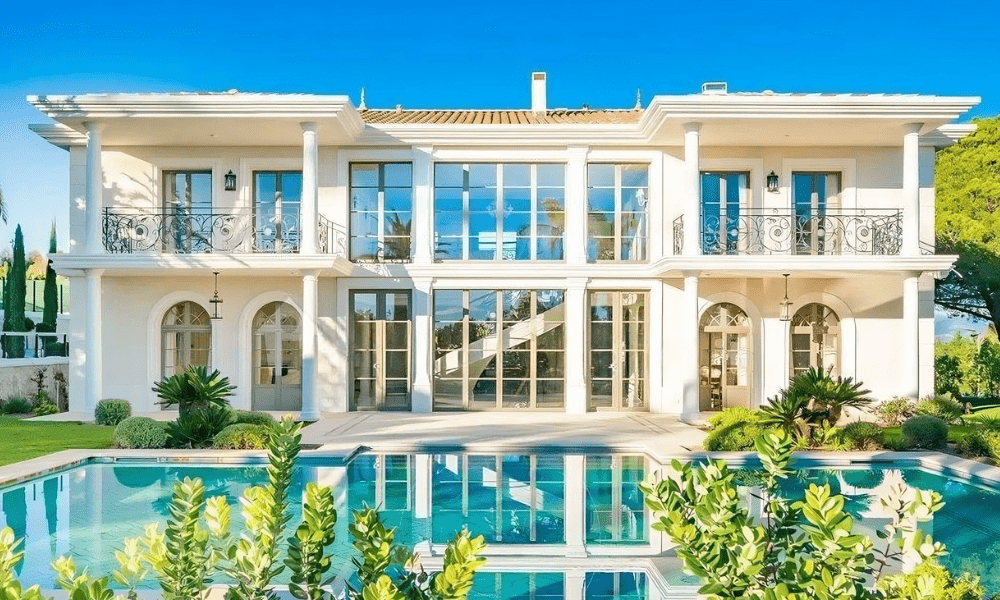 Outdoor infinity pool at Villa Hotel Brougham in Cannes, French Riviera, France – sun loungers on a terrace overlooking the Mediterranean