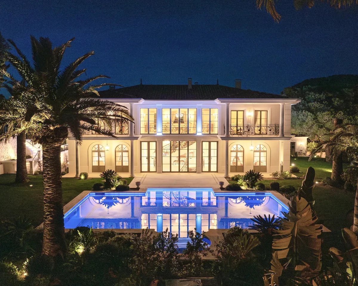 Evening view of Villa Hotel Brougham in Cannes, French Riviera, France – illuminated exterior reflecting in the pool