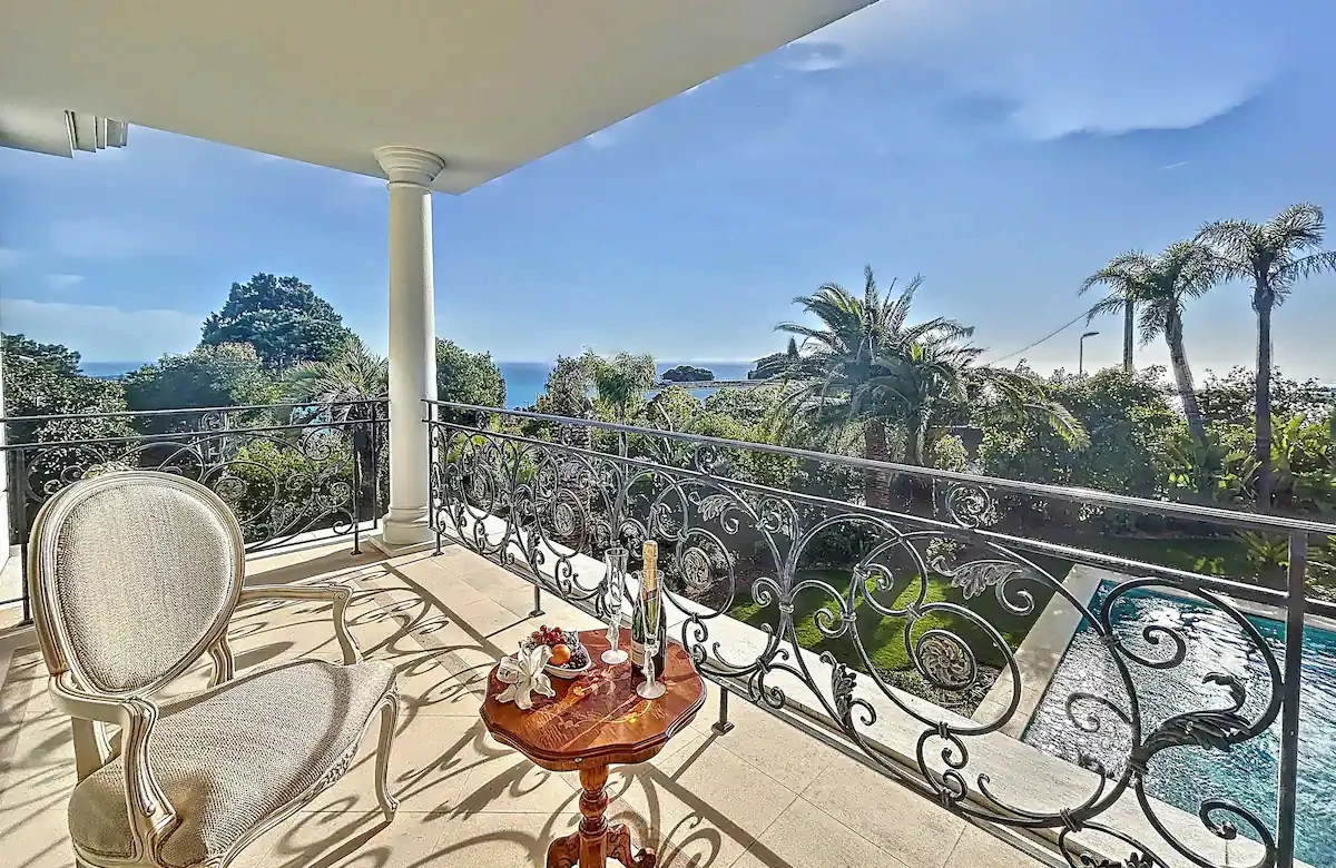 Master suite at Villa Hotel Brougham in Cannes, French Riviera, France – elegant bedroom with king-size bed and private balcony sea view