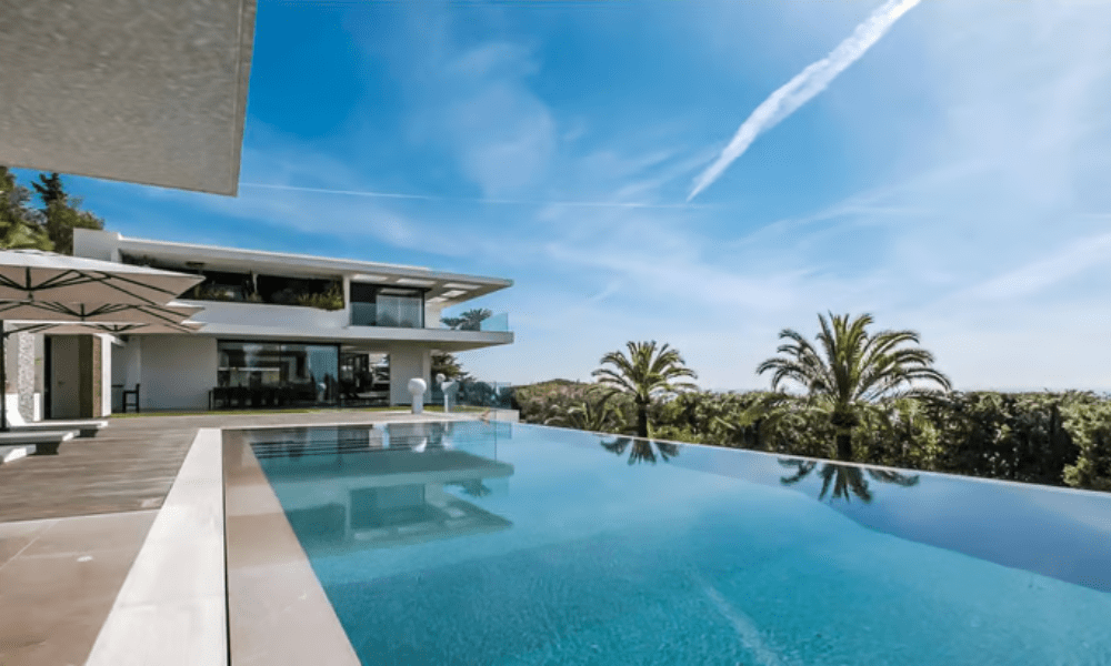 Villa Hotel Californie in Cannes, French Riviera, France – terrace with sun loungers and parasols framed by panoramic coastal vistas