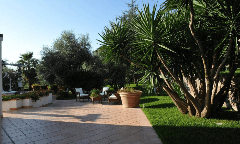 Villa Hotel Anacapri in Capri, Italy – lush garden terrace with wicker seating and olive tree accents