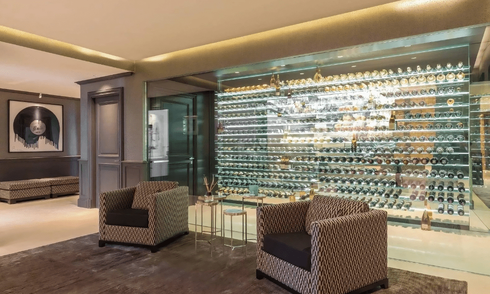 Luxurious private wine bar featuring an expansive wall-mounted wine rack, ambient lighting, and elegant seating.