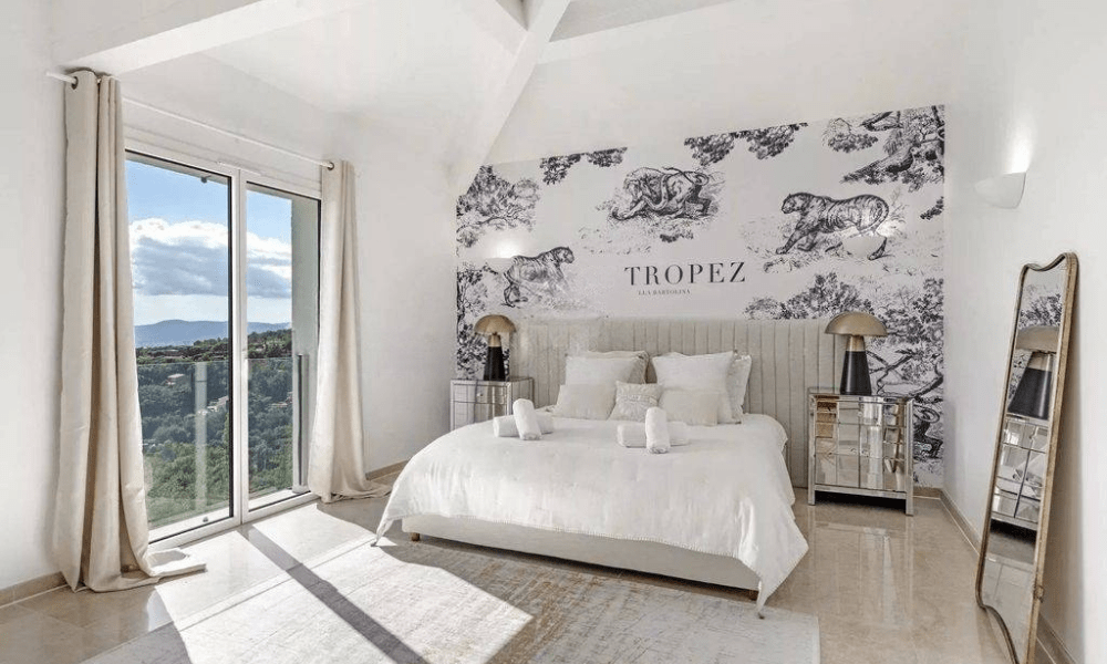 Villa Hotel Grimaud in Grimaud, French Riviera, France – bright guest bedroom with king-size bed and wood-beamed ceiling