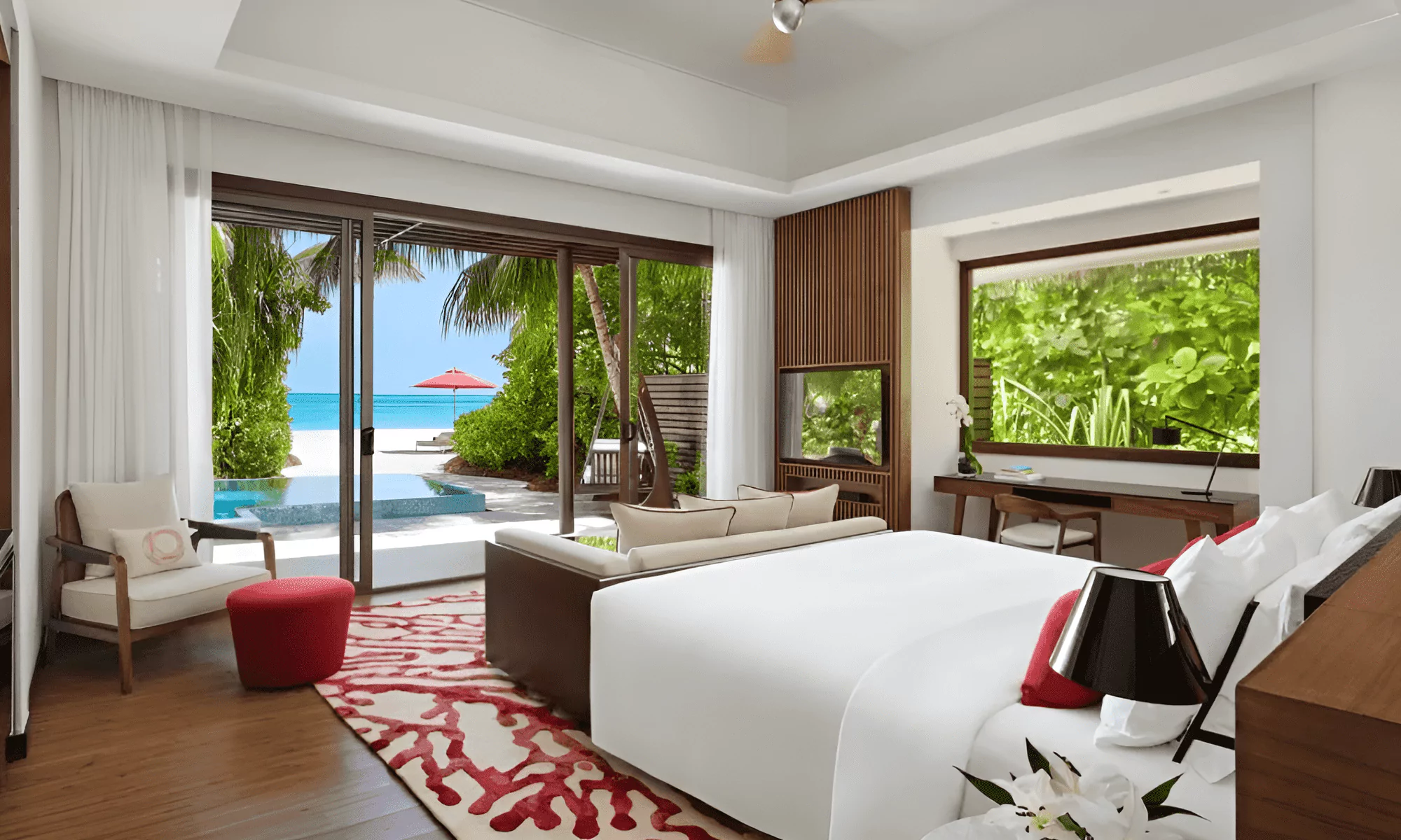 White sandy beach with luxury sun loungers and umbrellas.