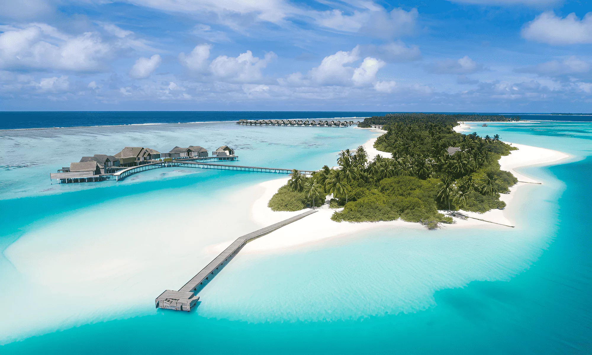 Crystal lagoon waters surrounding luxury overwater villas.