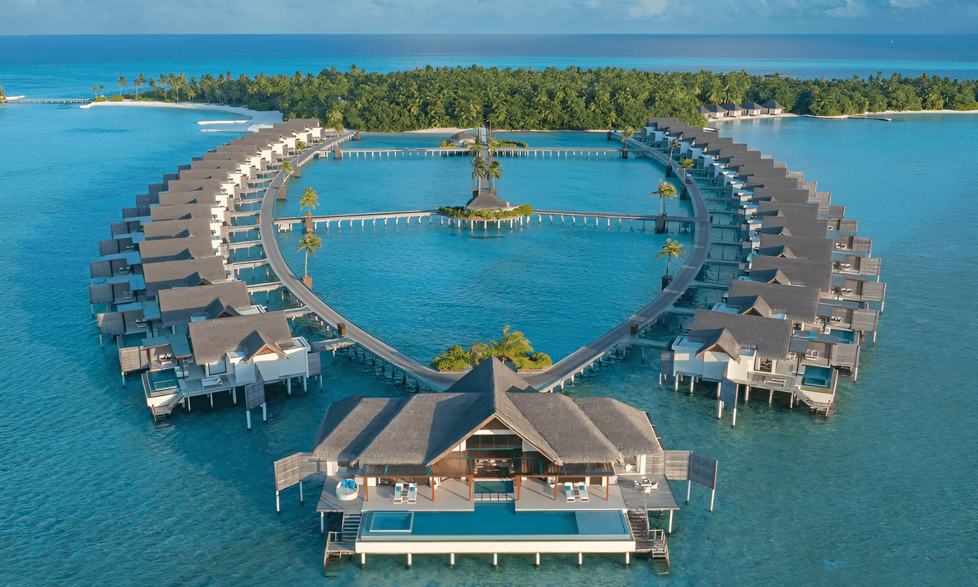 Aerial drone shot of luxury villas on a private island.