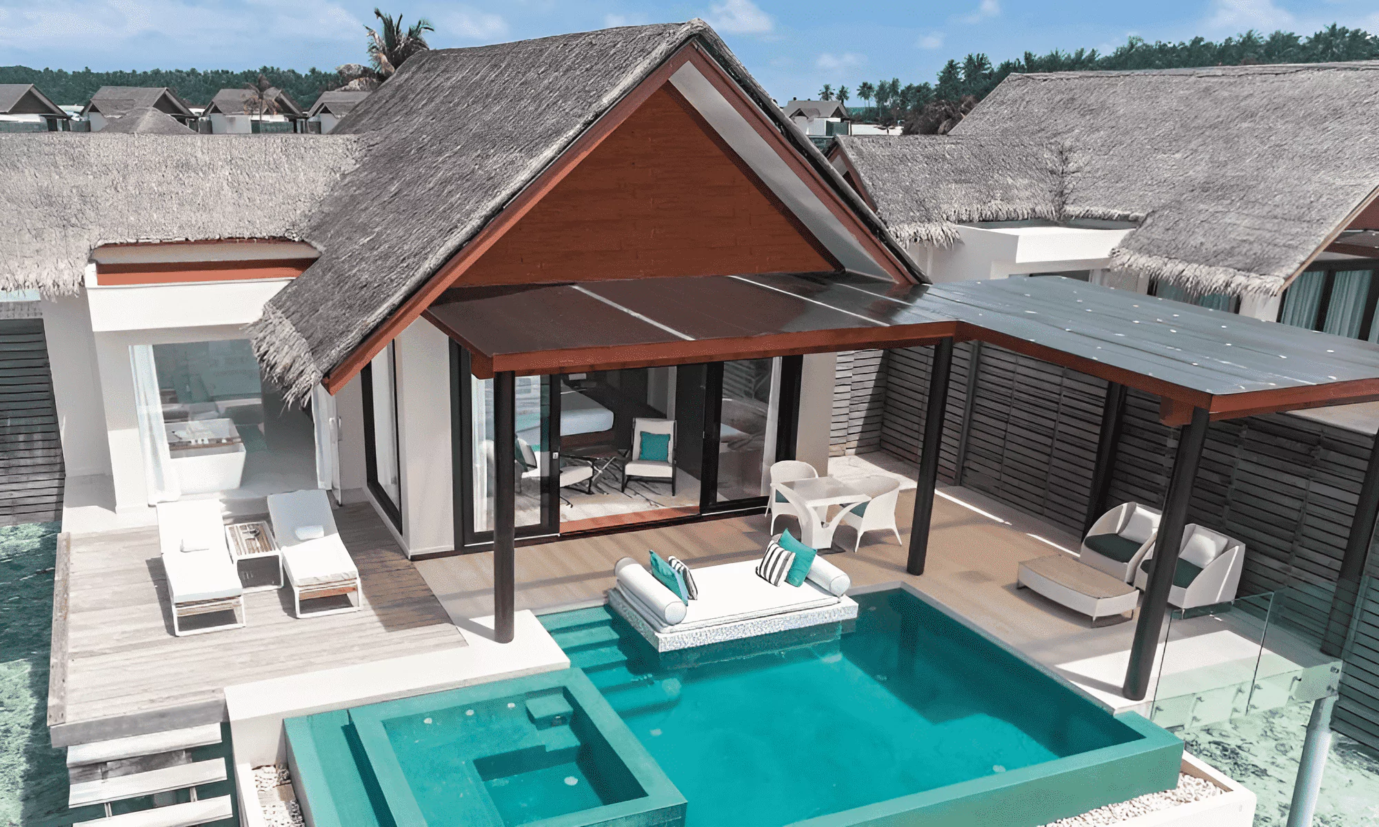 Luxury suite in the Maldives, with pool and sun loungers.