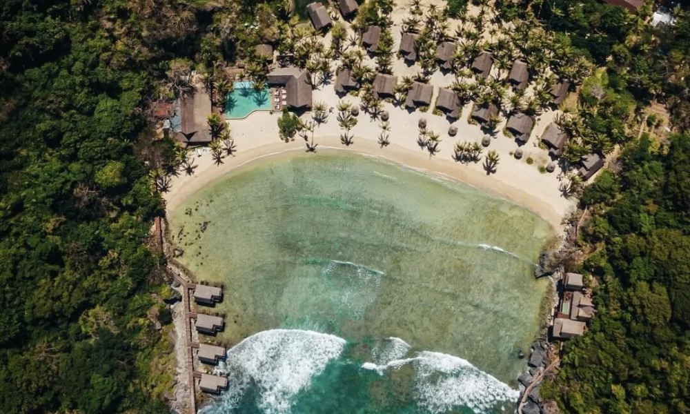 The Villa Hotels building can be seen atop the granite site, overlooking the ocean.