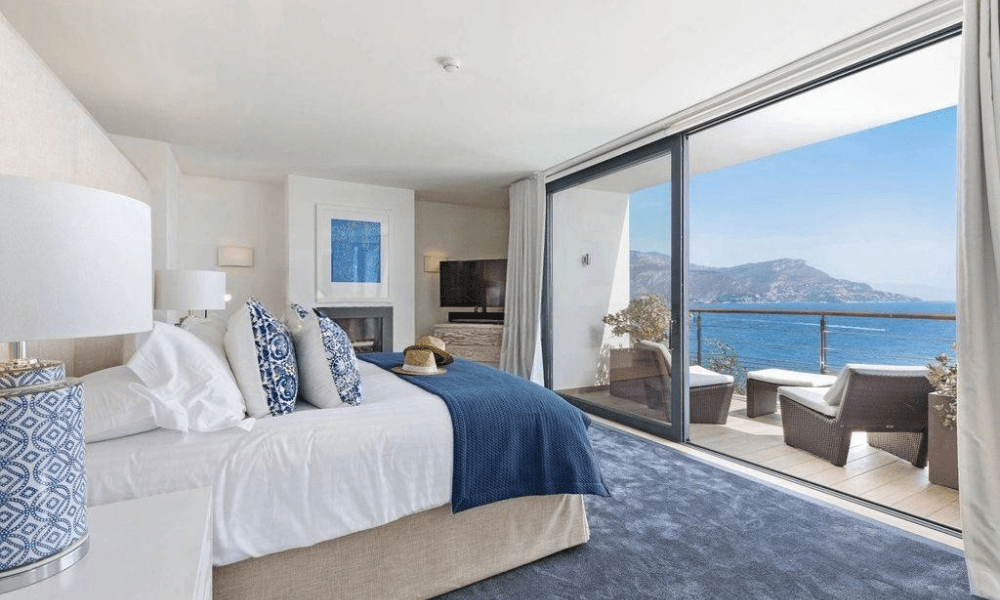 Poolside sunbeds with panoramic ocean backdrop