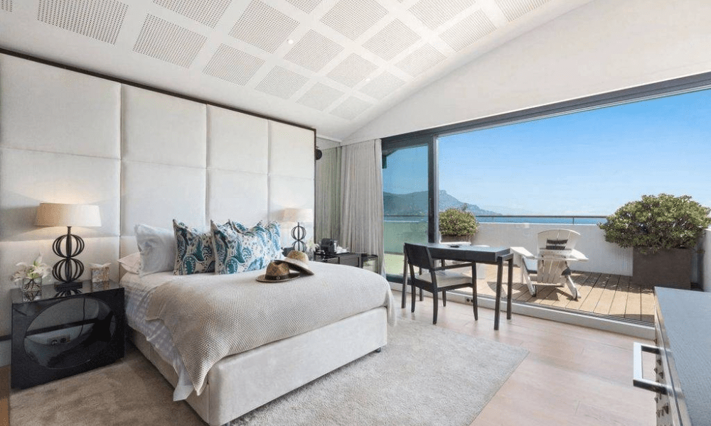 Stylish bedroom with large windows facing Mediterranean