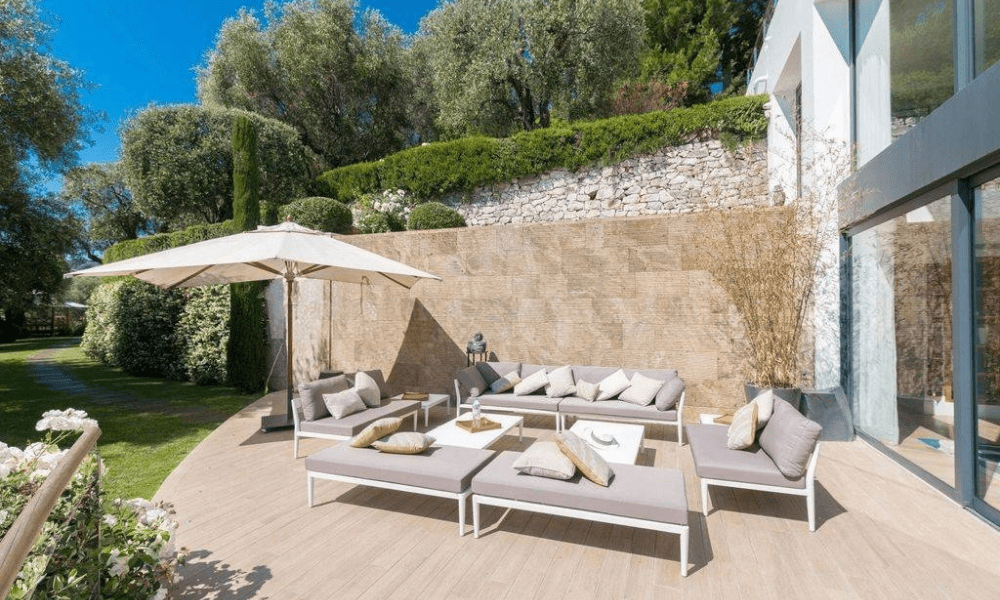 Shaded outdoor seating overlooking landscaped grounds
