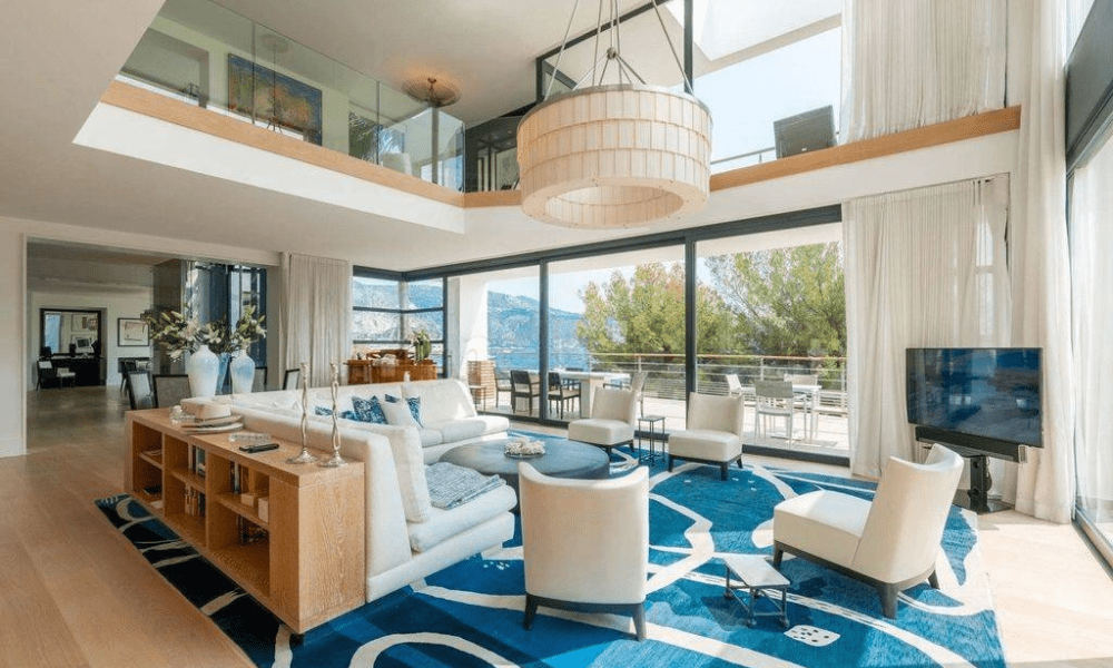 Wide-angle exterior shot capturing villa and sea horizon