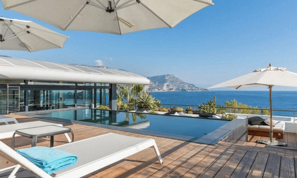 Evening view of pool and sea cliffs illuminated