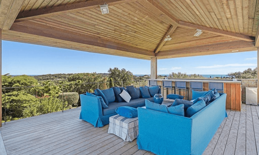 Modern living room with floor-to-ceiling windows and coastal views