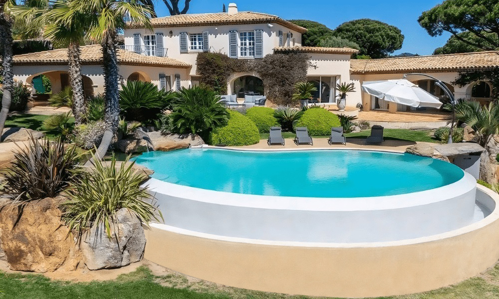 Wide-angle shot of villa exterior and coastal surroundings