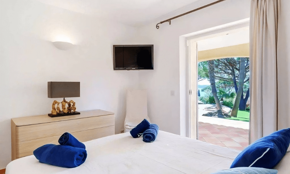 Cozy bedroom suite with plush bedding and terrace access