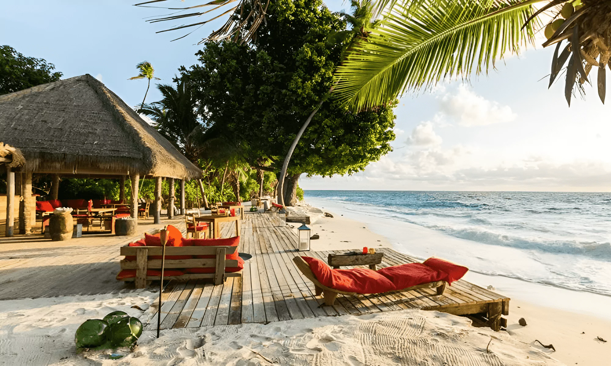 Private island beach with sun loungers overlooking the ocean.