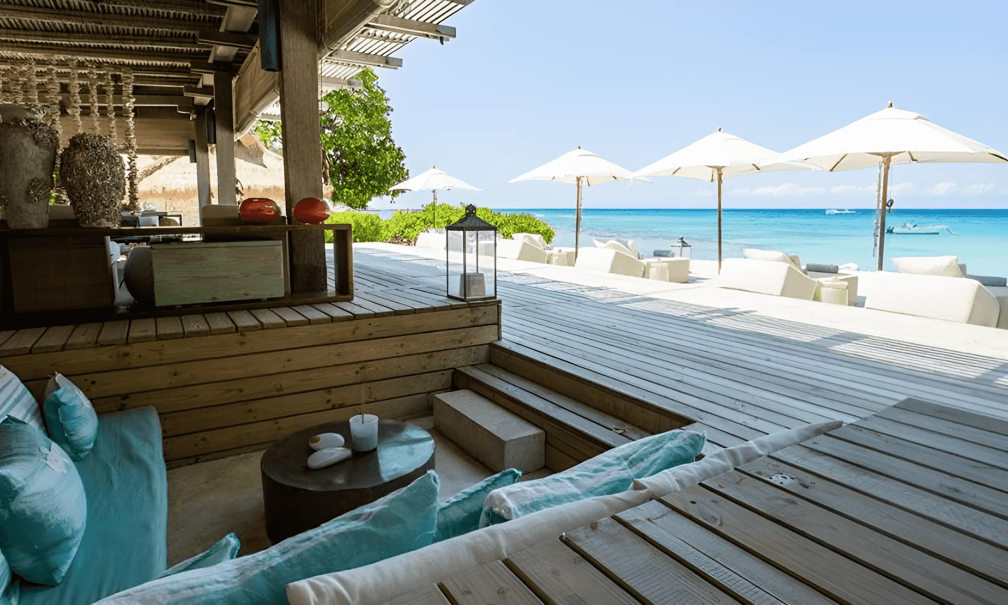 Beach with sun loungers and parasols on a private island in the Seychelles.