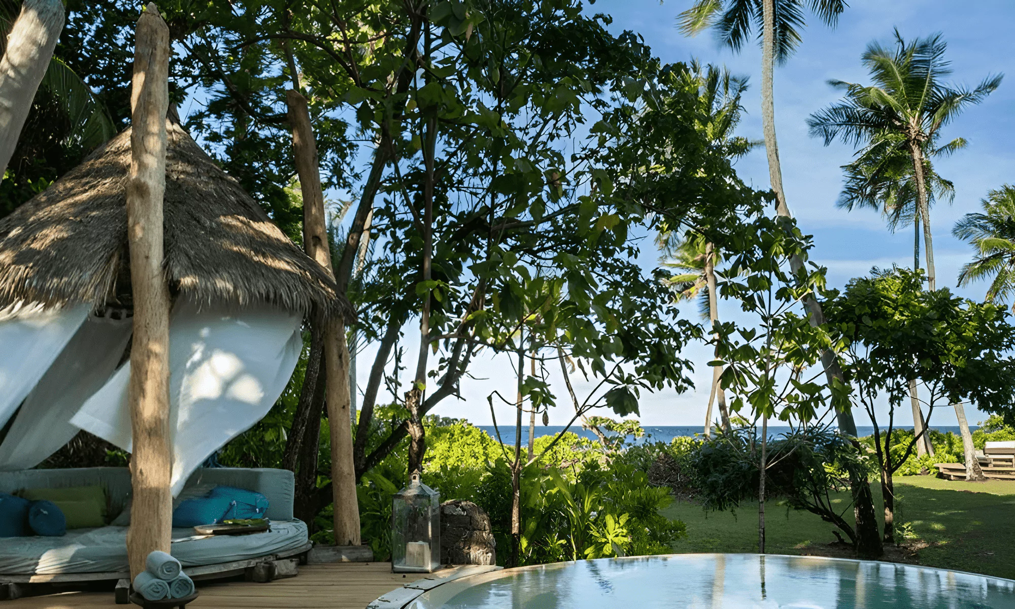 Circular pool with sun loungers.
