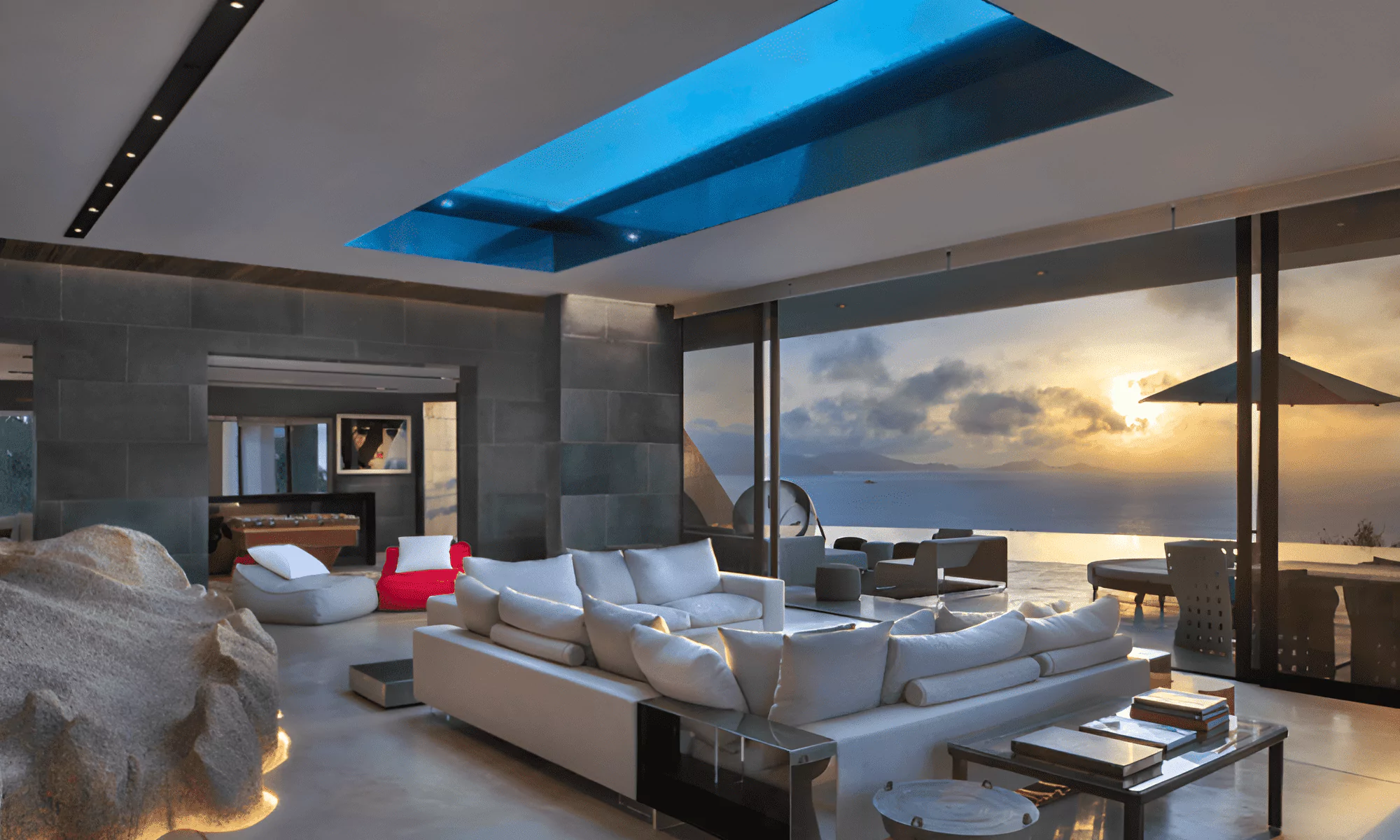 Villa Hotel lounge with views of the terrace and ocean from the top of the rock.