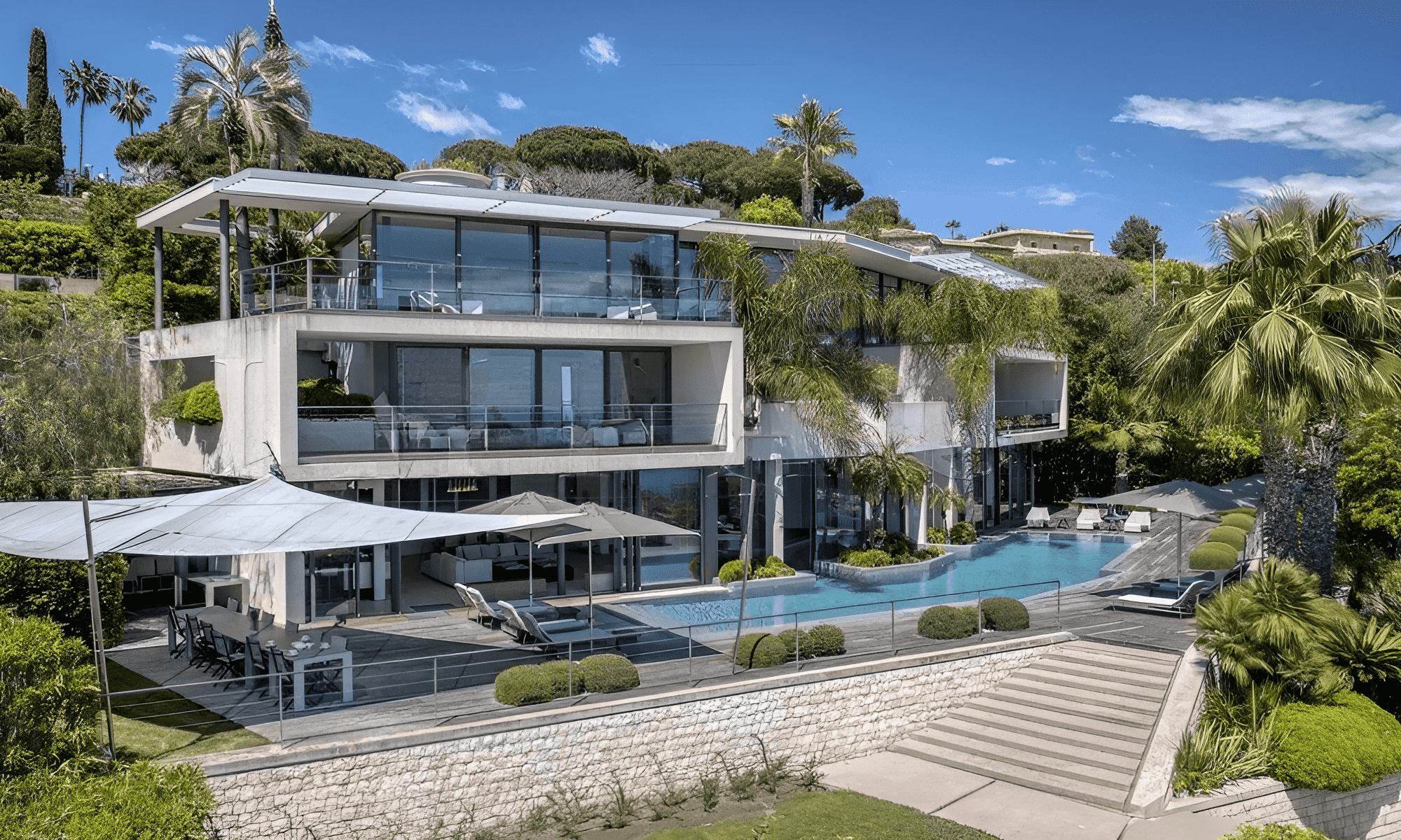 Villa Hotel Super Cannes in Vallauris, French Riviera, France – modern glass-front villa with infinity pool and palm-fringed terrace